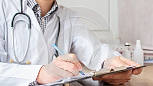 Medical professional doctor writing RX prescription on clipboard