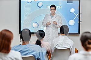 Medical professional giving lecture or presentation standing at seminar