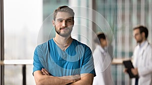 Medical professional portrait of confident young surgeon doctor man