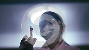 Medical Professional: Woman in Lab Coat with Syringe, Illuminated by Dimmed Light, Staring into the Camera