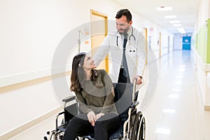 Medical Professional With Woman On Wheelchair At Hospital