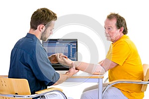 Medical professional works with patient in yellow. Testing function of arm-prosthesis.