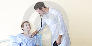 Medical professionals Caucasian man examining patient with stethoscope