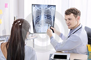 Medical professionals caucasian man holding xray and conversation