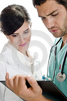 Medical professionals looking in writing pad
