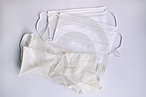 Medical protective disposable white masks and glove on white background. Protection equipment against virus, flu and COVID-19.