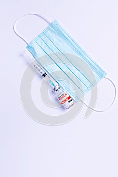 Medical protective face mask, syringe and covid-19 vaccine. Stop the spread of the coronavirus. White background and