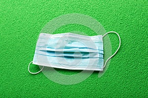 Medical protective mask on a green background