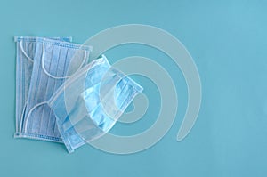 Medical protective masks lie on a blue background.