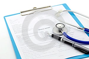 Medical questionnaire, stethoscope and pen on white background