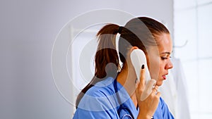 Medical receptionist answering phone calls from patient