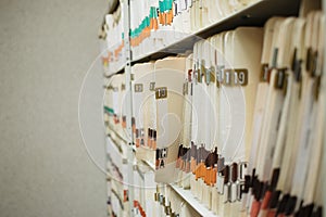 Medical record charts on shelve sorted alphabetically