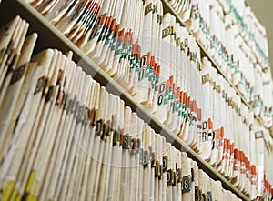 Medical record charts on shelve sorted alphabetically