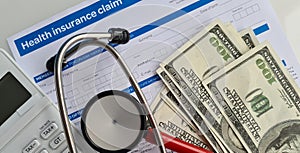 Medical reimbursement with health insurance claim form and stethoscope with money dollars