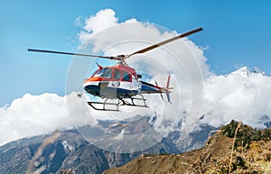 Medical Rescue helicopter landing in high altitude Himalayas mountains. Safety and travel insurance concept image