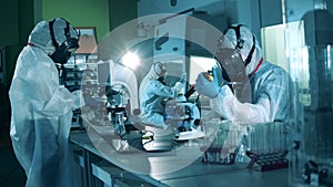 Medical research of antibodies to COVID-19. Scientific workers are operating microscopes in the laboratory