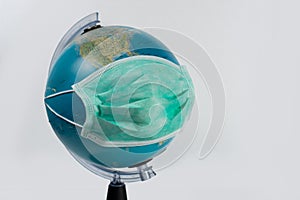 Medical respiratory mask that protects the population of the earth globe on a white background