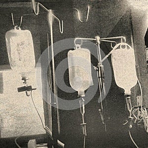 Medical Saline bag iv drop hang on metal black and white phonephotography.