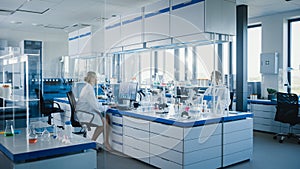 Medical Science Laboratory with Diverse Team of Biochemistry Scientists Developing Drugs, Female M