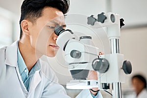 Medical, science and microscope with an asian man doctor working in a lab for research or innovation. Healthcare