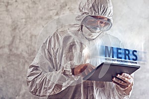 Medical Scientist Reading About MERS Virus on Figital Tablet Com photo