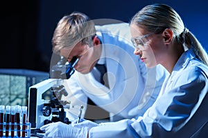 Medical scientists working in lab. Doctor teaching interns to make blood analyzing research. Coronavirus, biotechnology