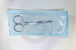 Medical scissors inside a sterilized blister ready for use it