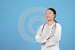 Medical Services. Confident Asian Doctor Woman In Uniform Standing With Folded Arms