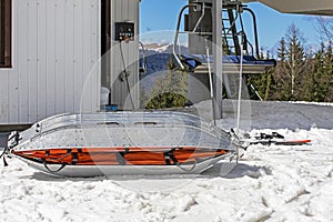 medical sled on a downhill slope for tramping downhill skiers and snowboarders. photo