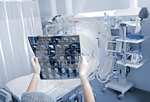 Medical specialist examines CT scan in ward