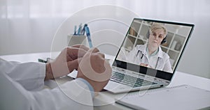 Medical specialist is learning online, listening and viewing lecture of experienced professor of medicine, female doctor