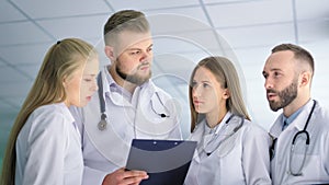 Medical specialist team talking with each other at hospital low angle