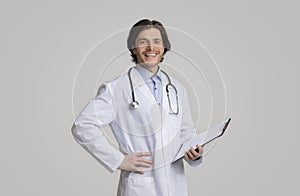 Medical Specialist In White Coat And Stethoscope Holding Clipboard With Prescriptions