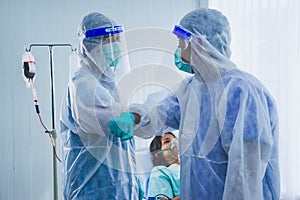 Medical specialists in PPE suit,greeting with social distancing, patient quarantine in sterile room,concept outbreak coronavirus