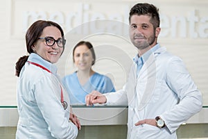 Medical Staff Having Discussion In Modern Hospital Corridor