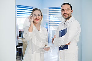 Medical Staff Having Discussion In Modern Hospital Corridor