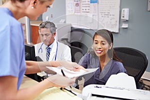 Medical Staff Meeting At Nurses Station