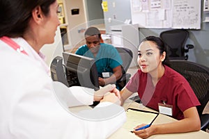 Medical Staff Meeting At Nurses Station photo