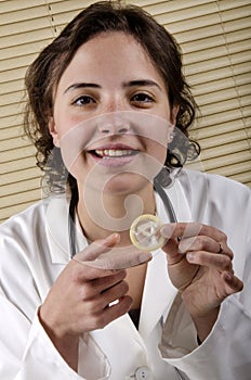 Medical staff member holding a condom