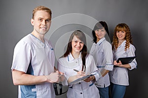 Medical staff. Portrait of doctors of otolaryngologists and nurses on an isolated grey background photo