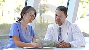 Medical Staff Review Information On Digital Tablet