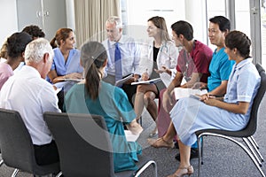 Medical Staff Seated In Circle At Case Meeting