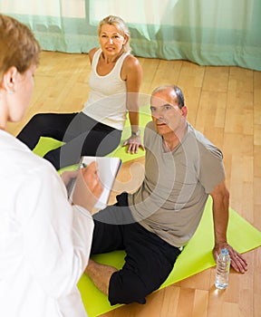 Medical staff with senior people at gym