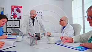 Medical staff talking with teamworker in hospital office