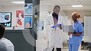 Medical staff team looking at insurance files in hospital lobby