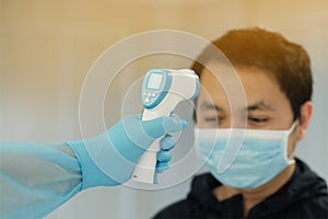 Medical staff use infrared forehead thermometer for check body temperature, Covid-19 outbreak concept