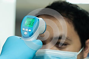 Medical staff use infrared forehead thermometer for check body temperature, Covid-19 outbreak concept