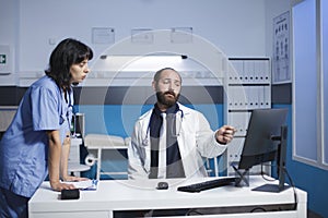 Medical staff using desktop pc in office