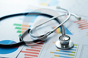 Medical statistics and graphic charts with stethoscope photo