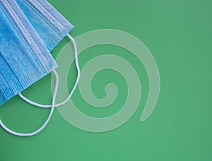 Medical sterile protective blue masks on a green background